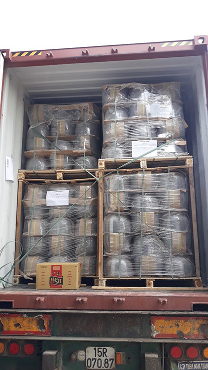 Goods loaded on pallet covered by plastic film and fastened by strings